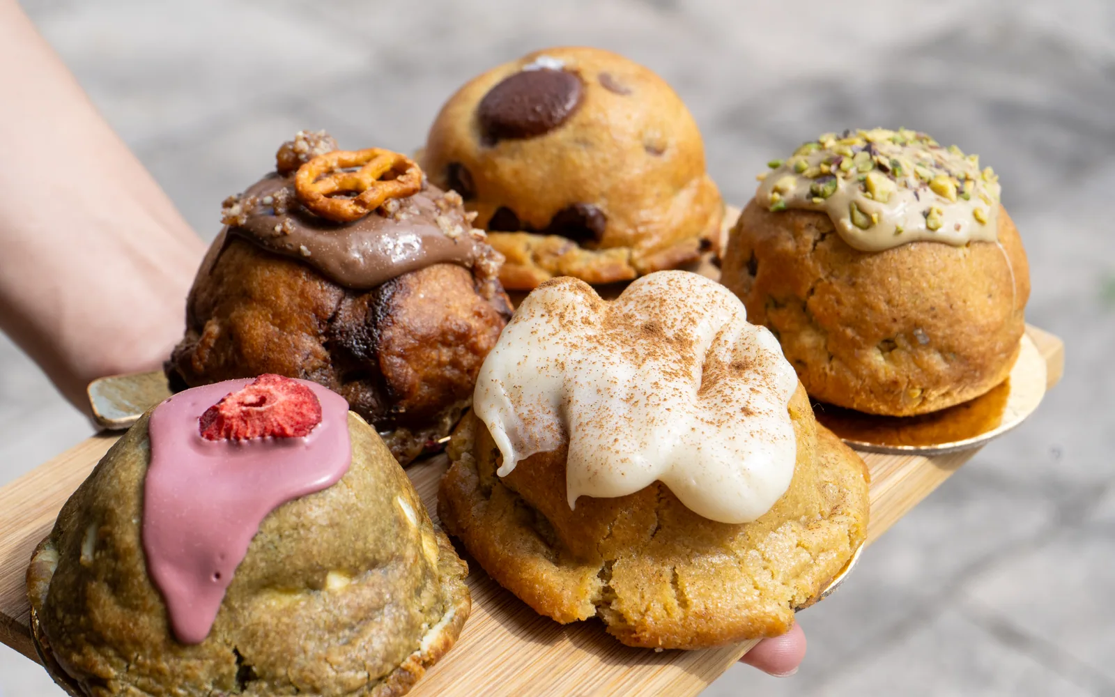 A board of Cookie Beacon chunky cookies topped with pistachio, chocolate, pretzel and freeze-dried strawberry