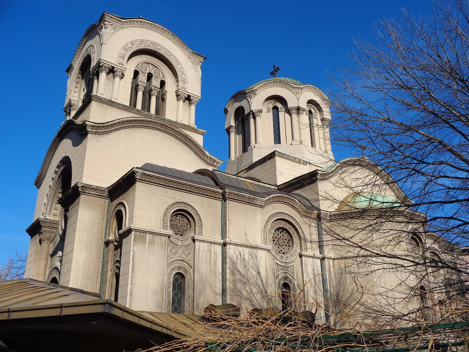 The Church of St Alexander Nevsky on Cara Dušana in Belgrade: pale stone walls, a tall bell tower and a dome under a blue sky
