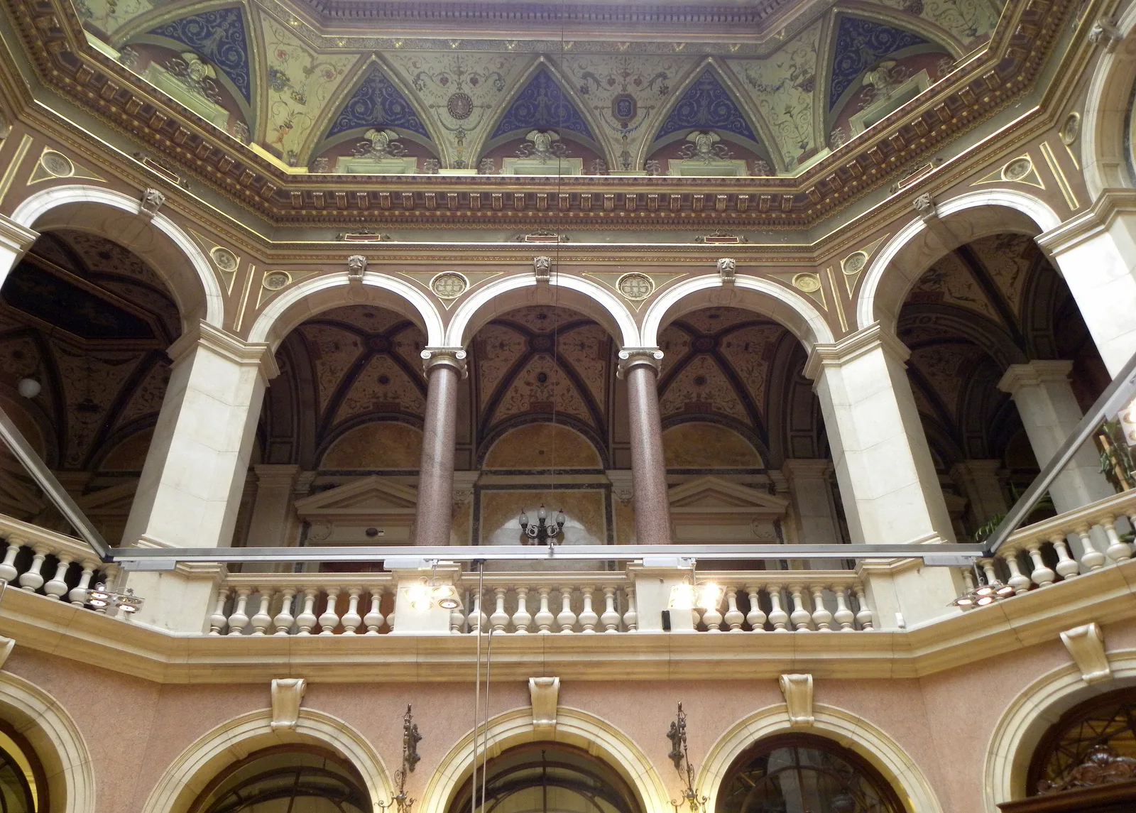 The former tellers' hall of the National Bank of Serbia at Kralja Petra 12, Belgrade: two levels of arches with a balustrade and a painted ceiling
