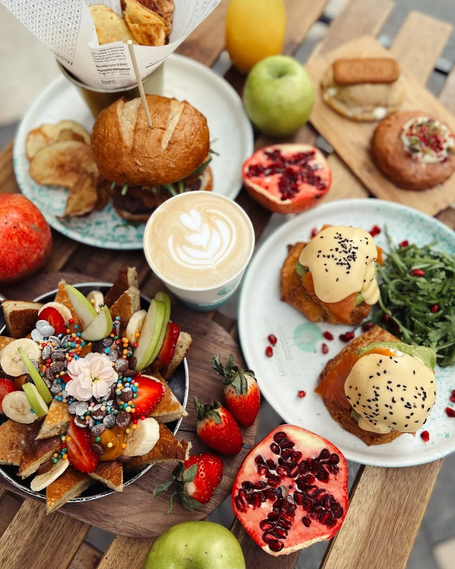 A Cookie Beacon brunch spread — waffles, eggs benedict with salmon, French toast, latte art and fresh fruit