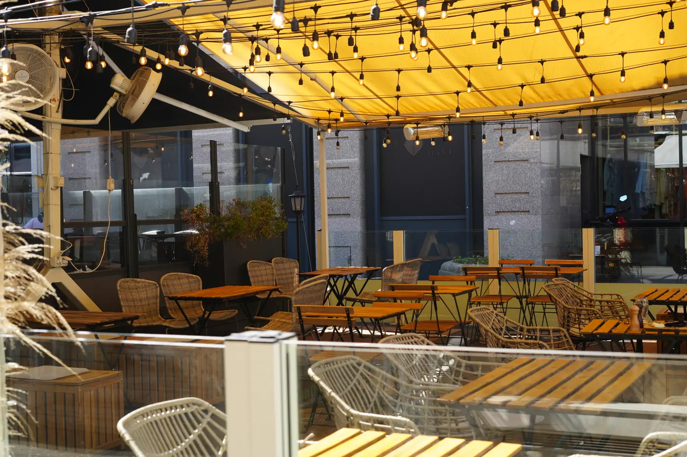 The terrace under the yellow awning and festoon lights at Cookie Beacon Kralja Petra in Belgrade