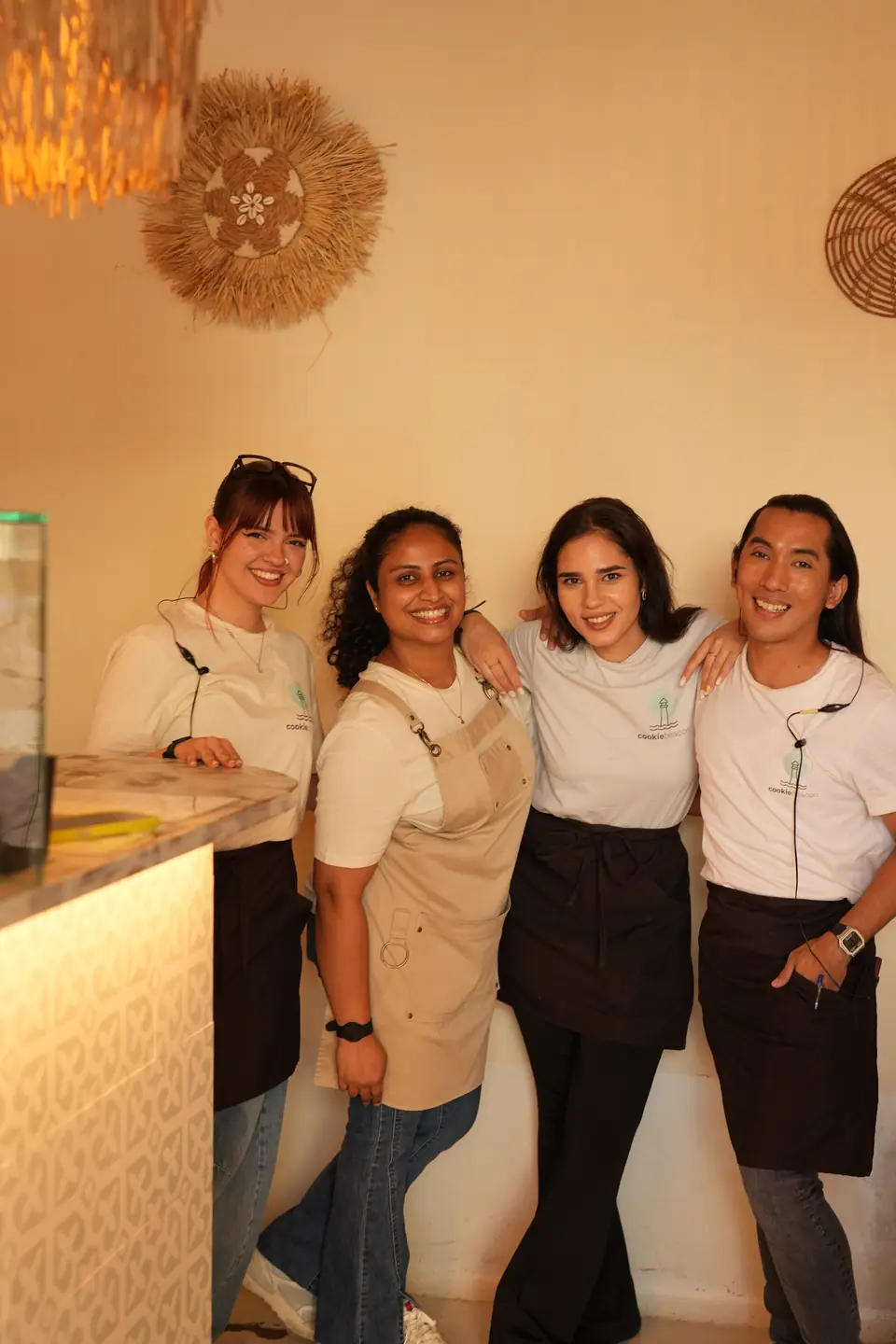 Four of the Cookie Beacon team standing together in front of the patterned tile counter at the Amzei café on Strada General Christian Tell, Bucharest