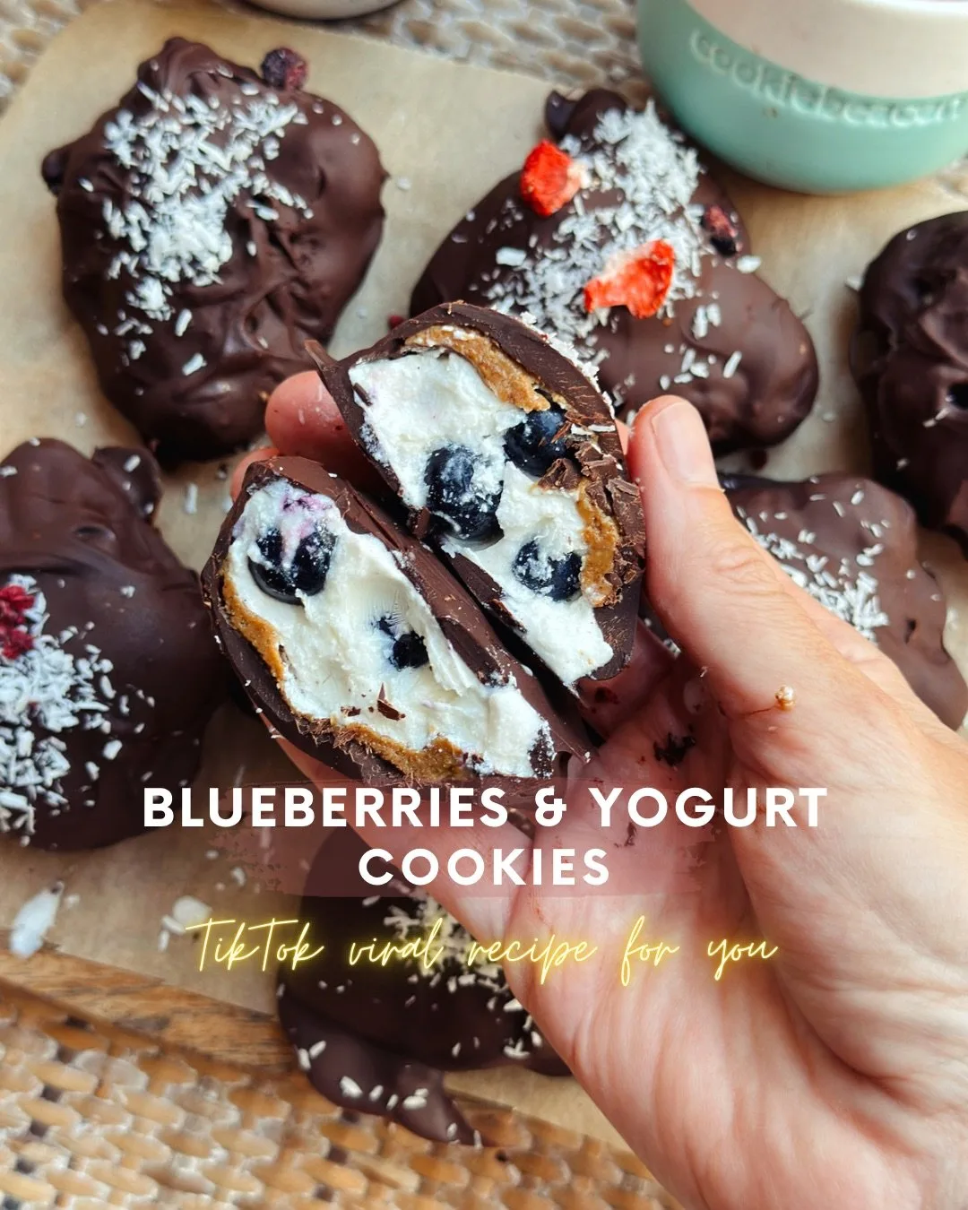 Frozen blueberry yogurt cookies dipped in dark chocolate on baking paper