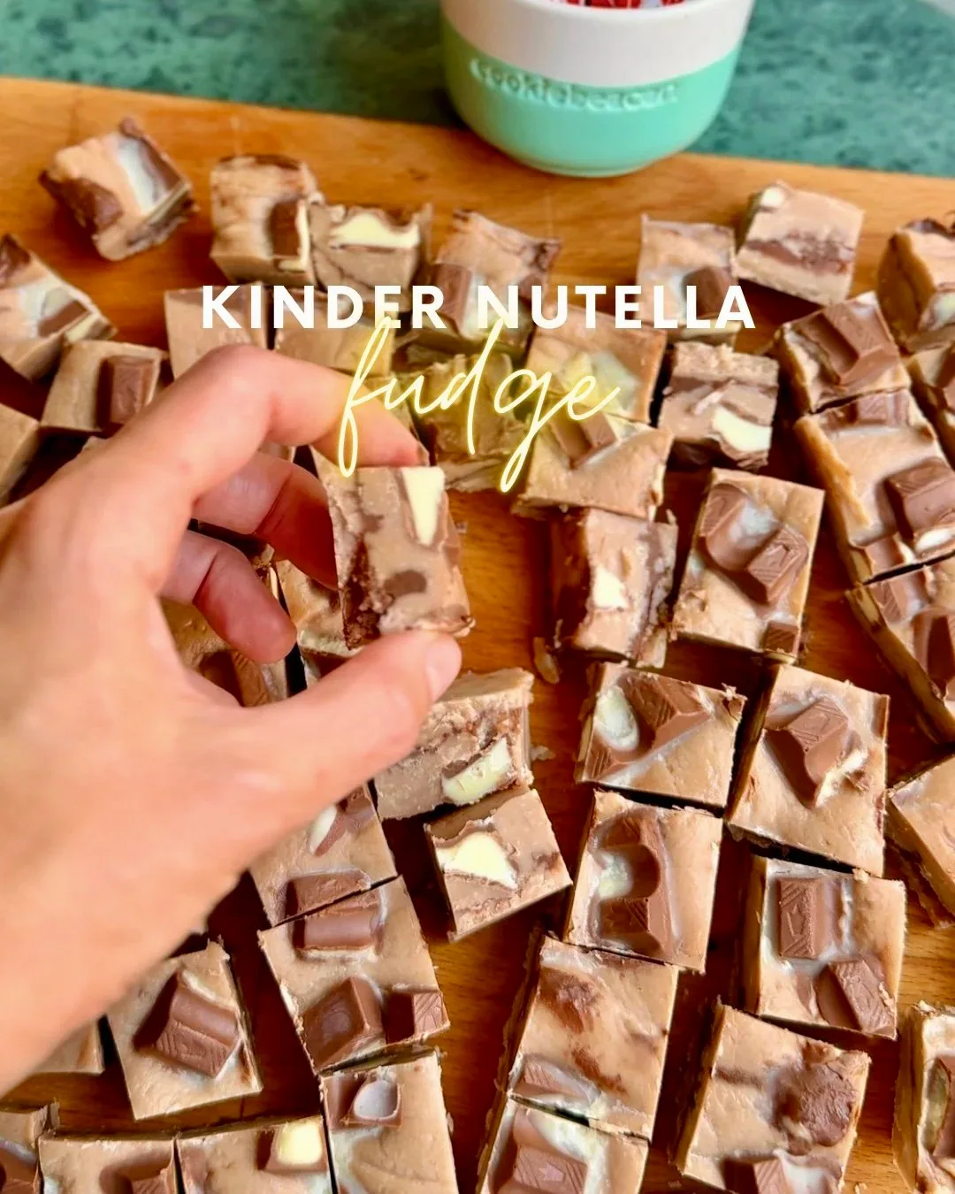Squares of Kinder Nutella fudge with a Nutella ripple and Kinder chocolate chunks on top