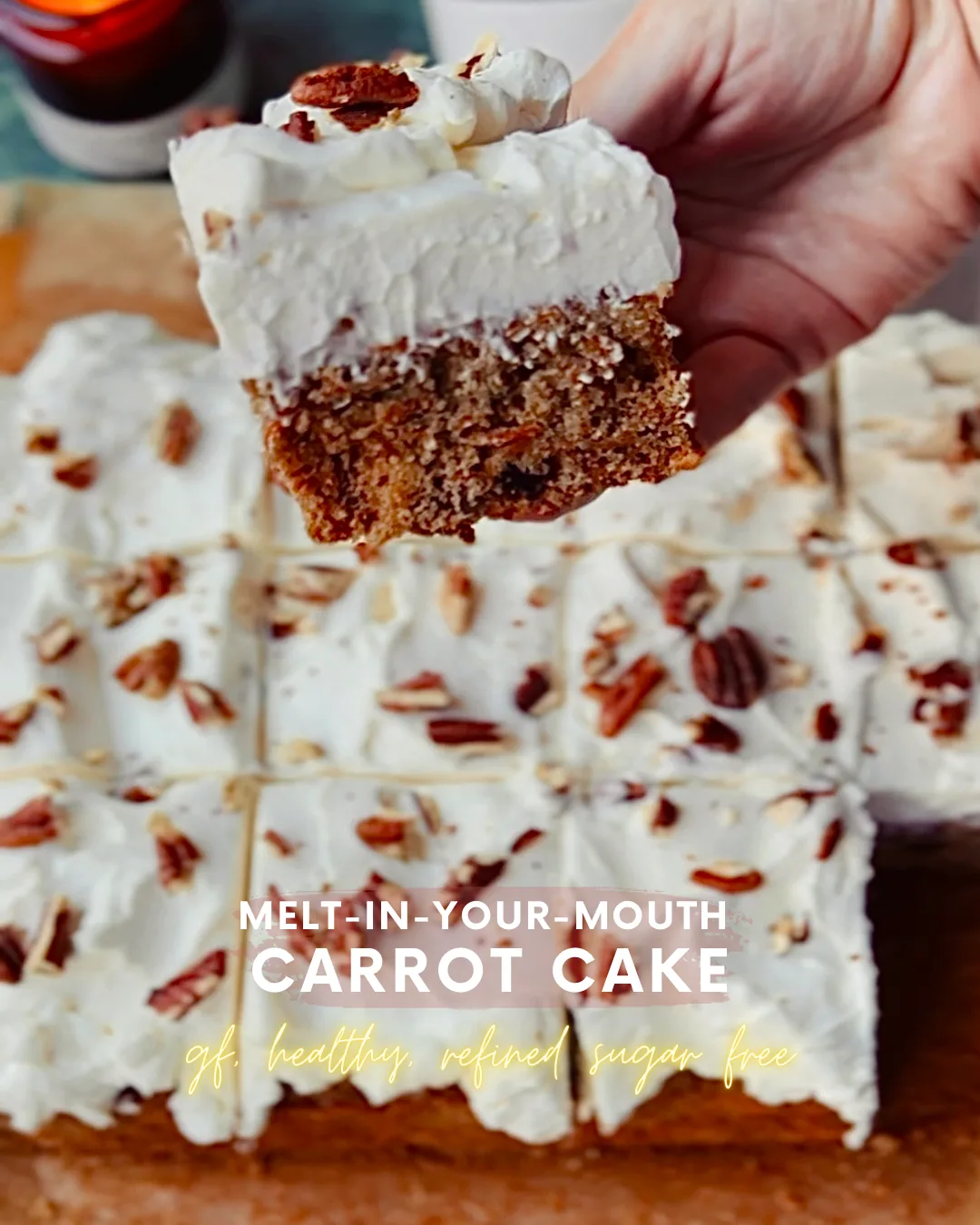 A slice of gluten-free carrot cake topped with fluffy cream cheese frosting and chopped pecans