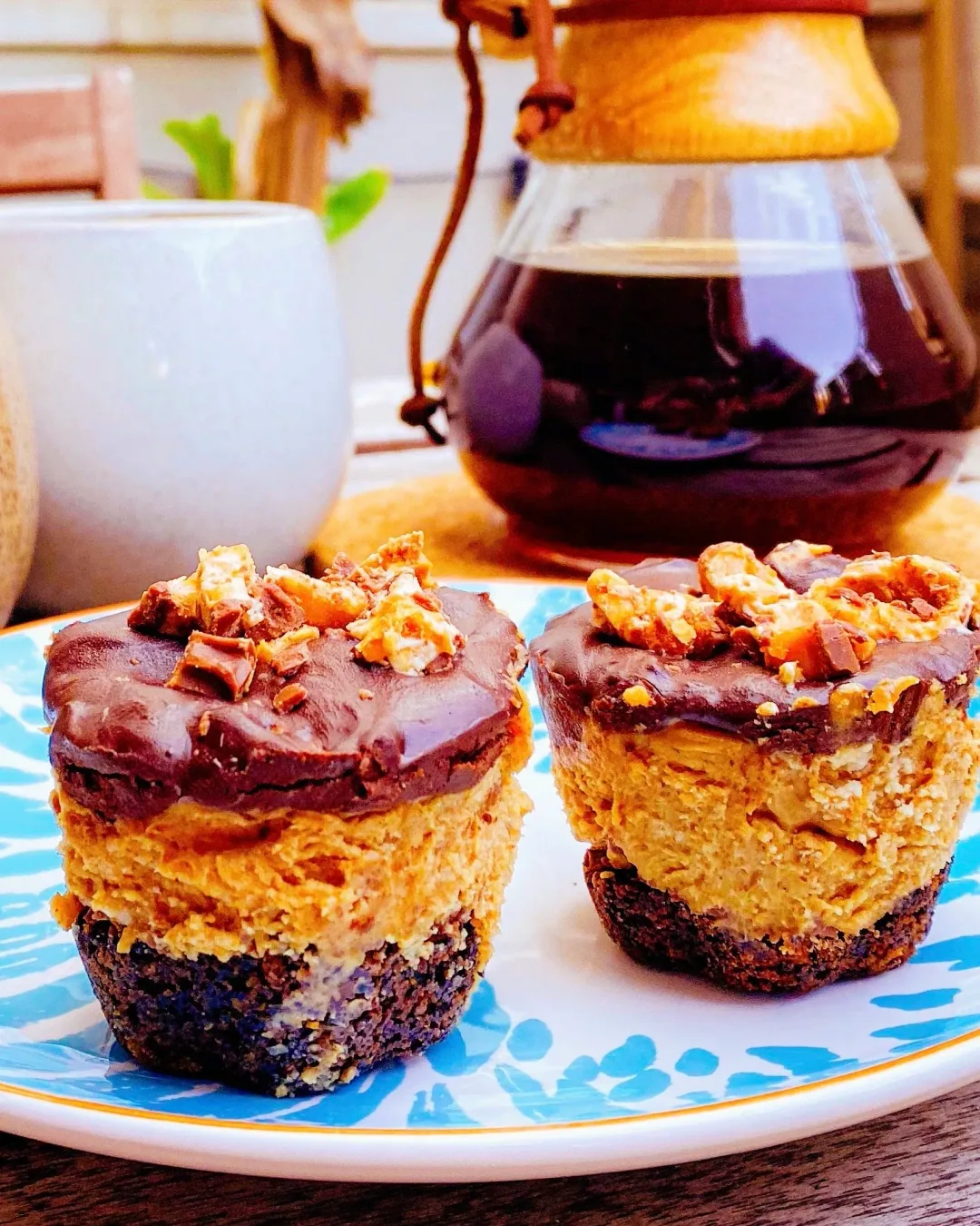 Mini pies with an Oreo crust, chocolate ganache top and crushed Snickers pieces scattered over
